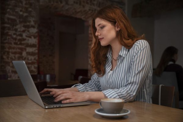 medium-shot-woman-with-laptop-coffee-shop